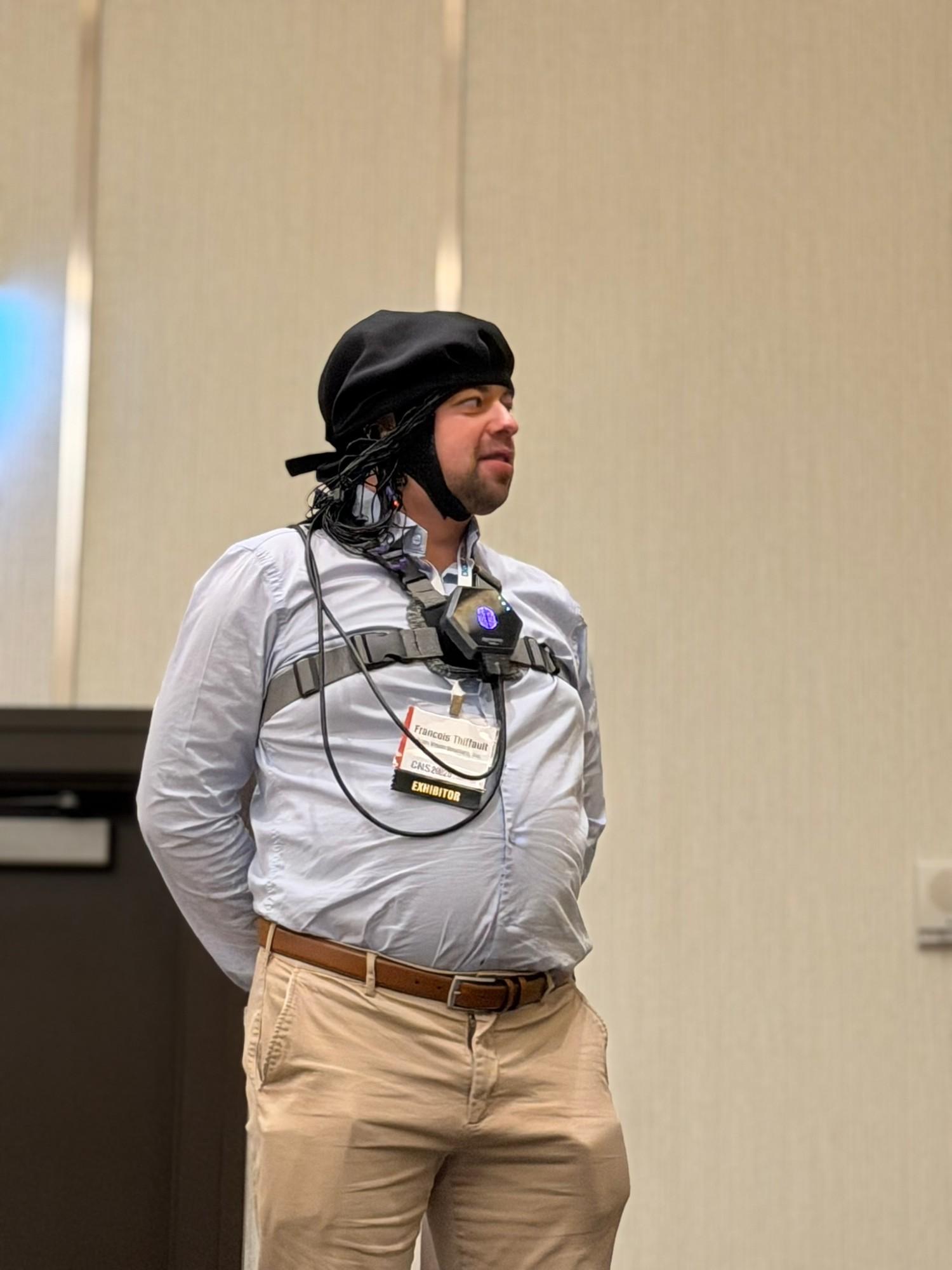 A person wearing a mobile EEG cap and body-worn sensors